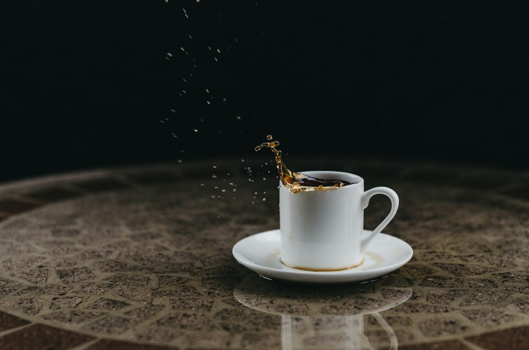 Coffee splashing from a cup on a table